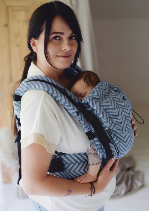 Little Frog Prime Carrier Nordic Miles met blauw zigzagpatroon, gedragen met een slapende baby op de buik